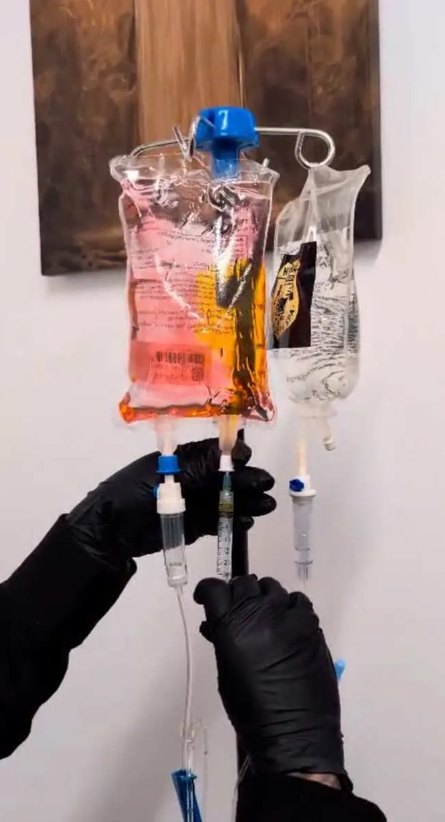A Hydration Medic paramedic preparing a vitamin IV drip bag