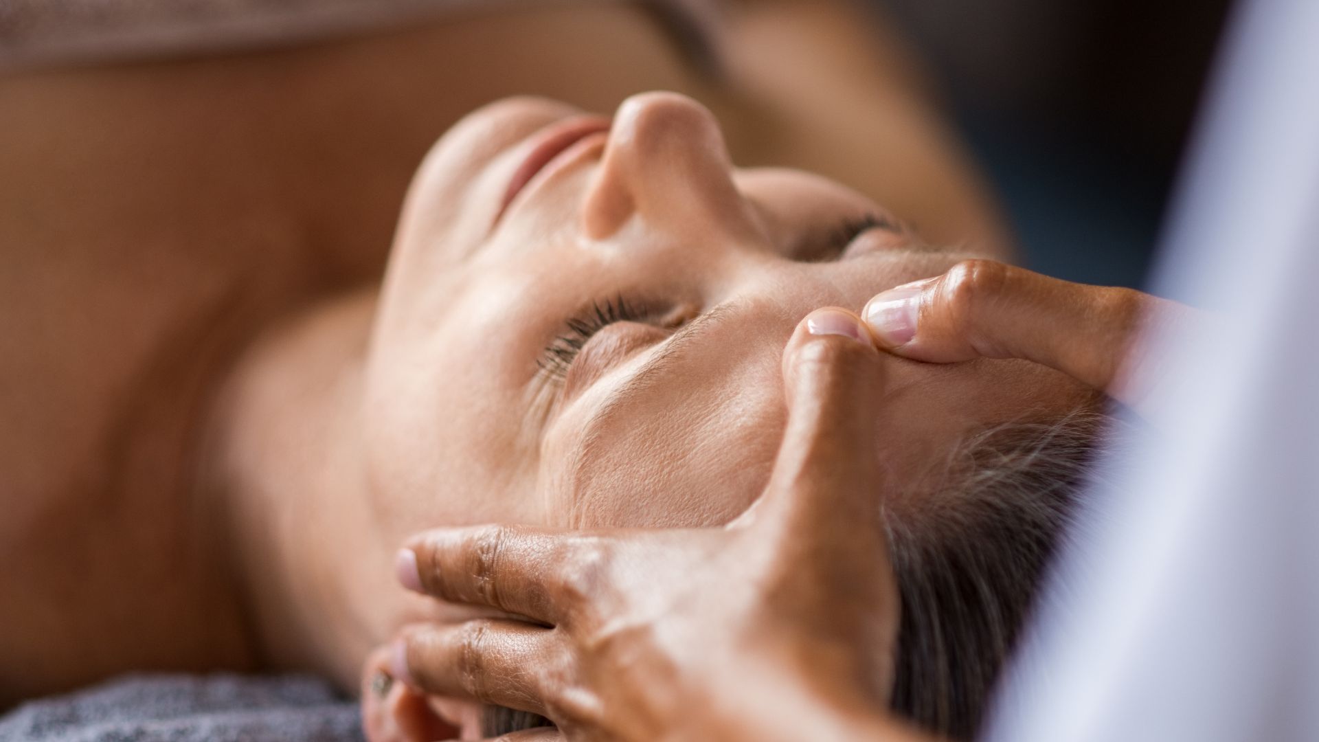 Client receiving a Vitamin C brightening facial in Westchester County.