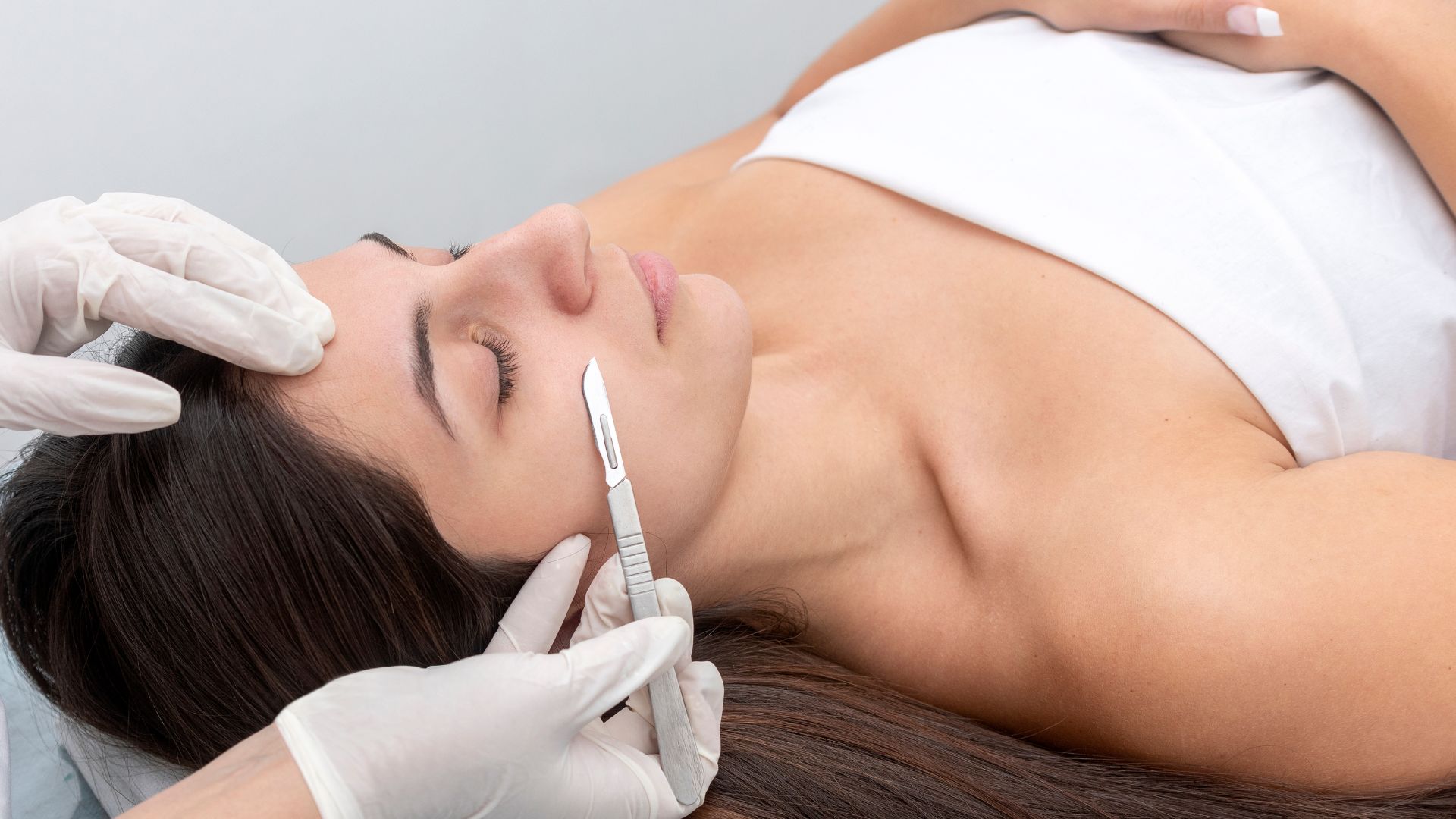 A professional aesthetician performing a Dermaplaning treatment in Westchester County.