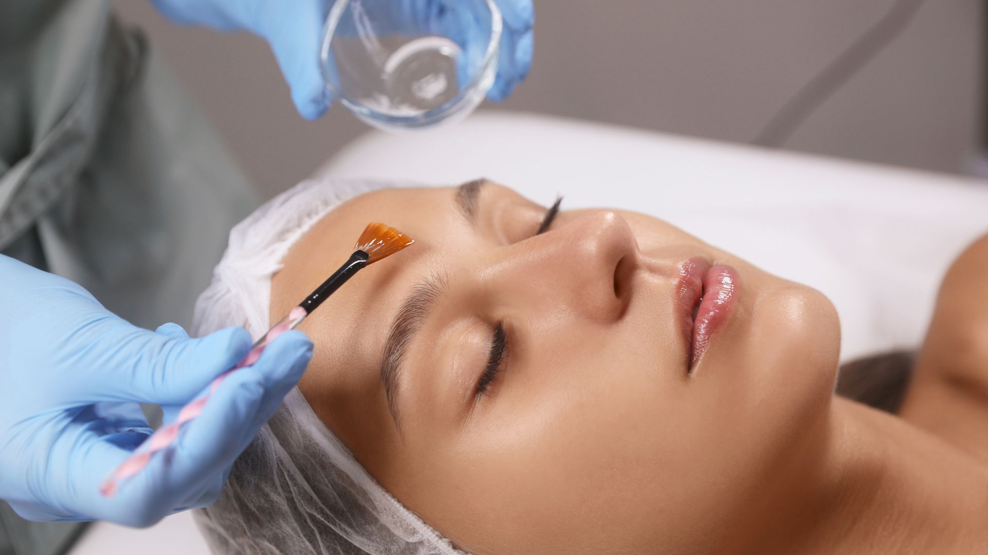 A professional aesthetician applying a chemical peel treatment in Westchester County.