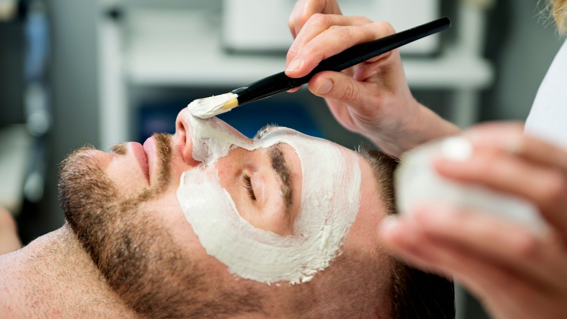 A man receiving a professional deep cleansing facial in Westchester County.