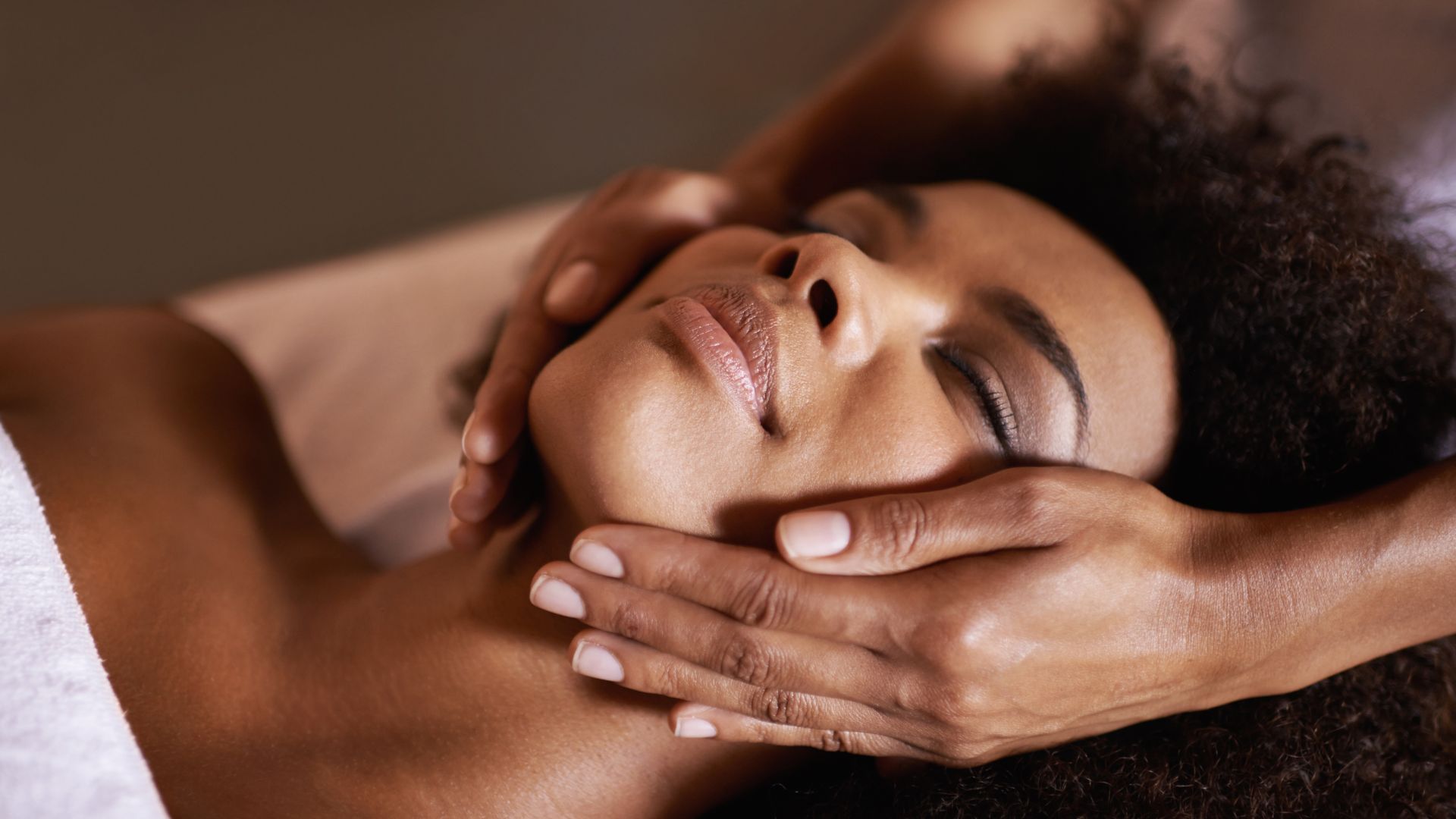 Client receiving a hydrating and supportive facial for psoriasis-prone skin.