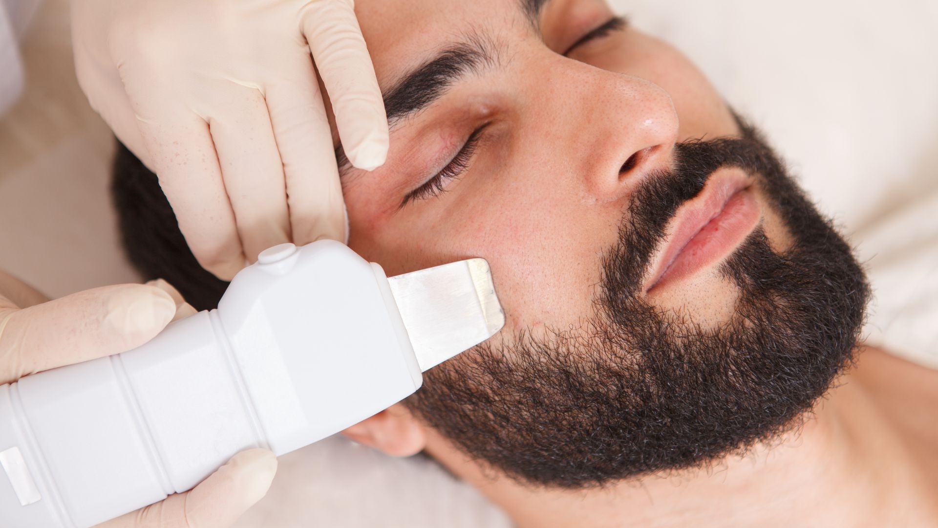 A professional aesthetician treating the beard and shave area to prevent ingrown hairs.